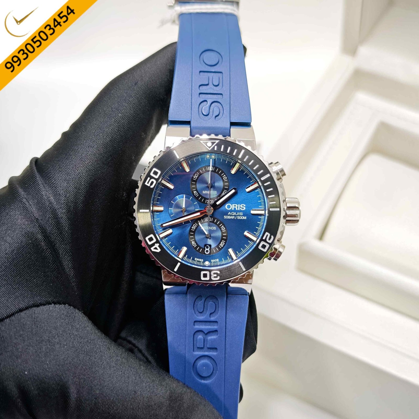 Oris Aquis Chronograph 50 BAR stainless steel Swiss watch featuring a striking blue dial, durable blue rubber strap, automatic chronograph movement, and professional-grade 50 BAR water resistance.
