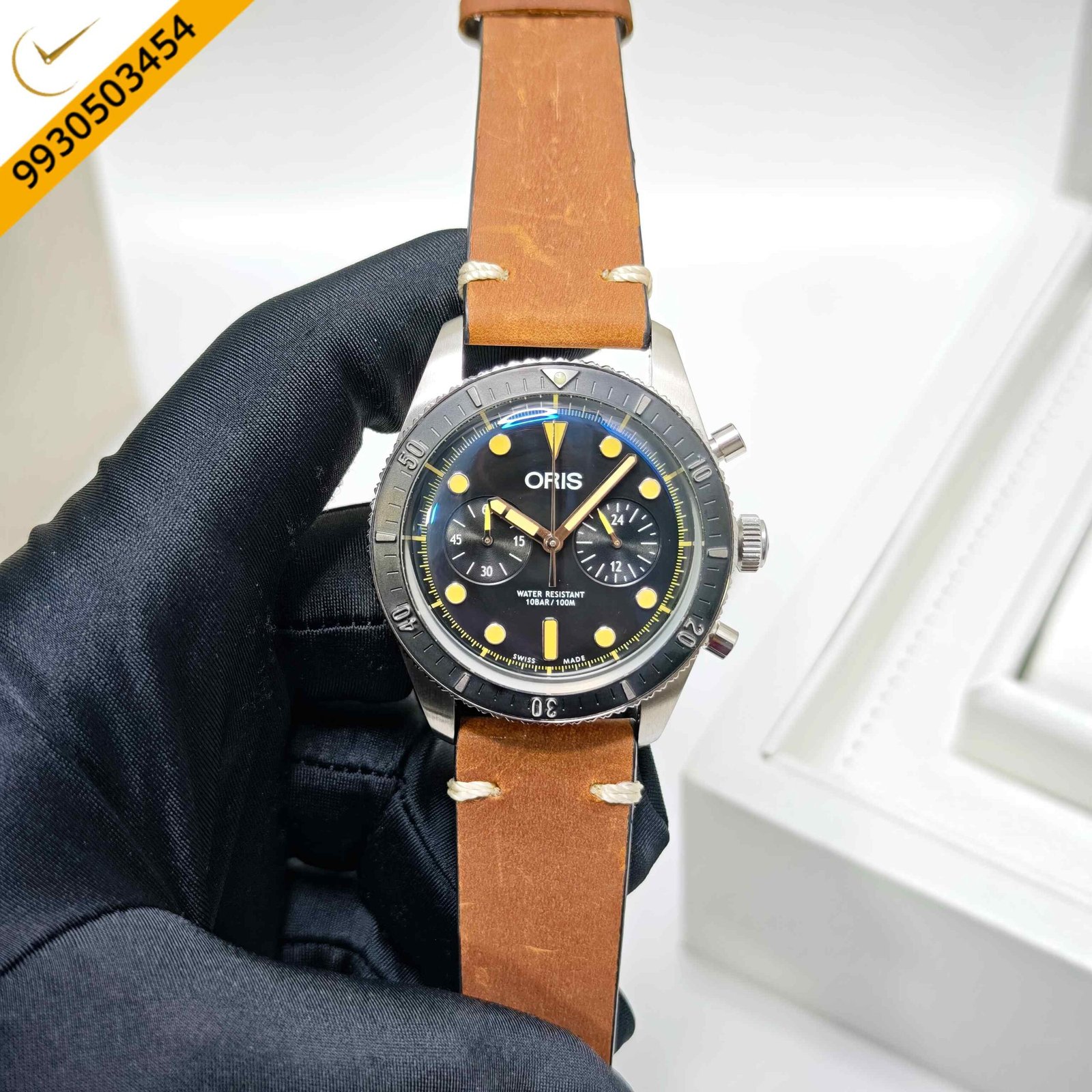 Oris Carl Brashear Chronograph Limited Edition Swiss automatic watch featuring a black dial, stainless steel case, bronze bezel, and brown leather strap with vintage-inspired luxury design.