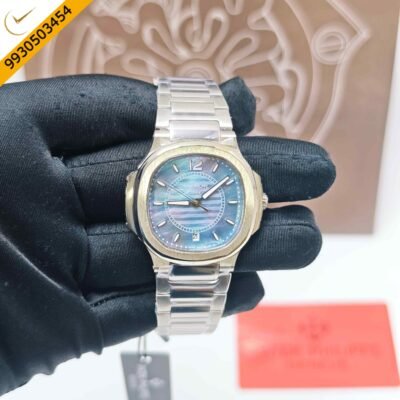 Patek Philippe Nautilus stainless steel watch featuring a vibrant rainbow dial, integrated steel bracelet, Swiss Semi ETA quartz movement, and luxurious sporty-elegant design.