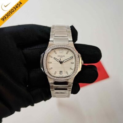 Patek Philippe Nautilus stainless steel watch featuring a white dial, diamond-set case, Swiss Semi ETA quartz movement, and luxurious sporty-elegant design.