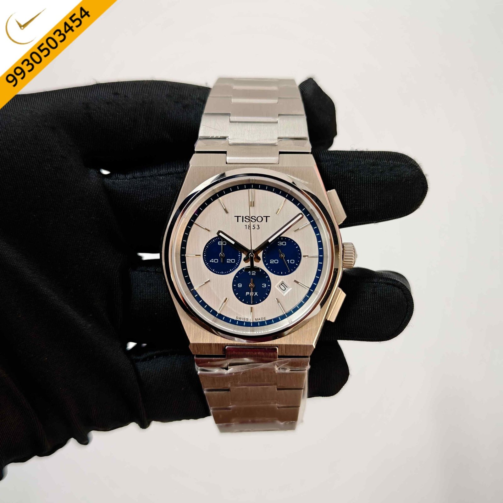 Tissot PRX Chronograph stainless steel Swiss watch featuring a white dial with blue chronograph subdials, integrated steel bracelet, sapphire crystal, and premium Swiss craftsmanship.